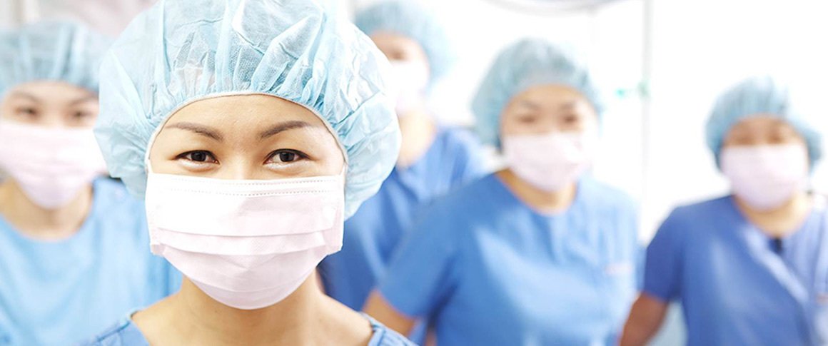 Medical staff wearing surgical uniforms and masks at 365mc’s hospital facility ensuring safety and expertise.